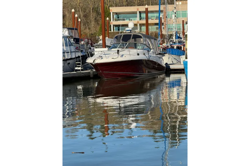 Slide: The Image of 2006 Sea Ray 340 Sundancer docked at marina, reflecting on calm water. - 36