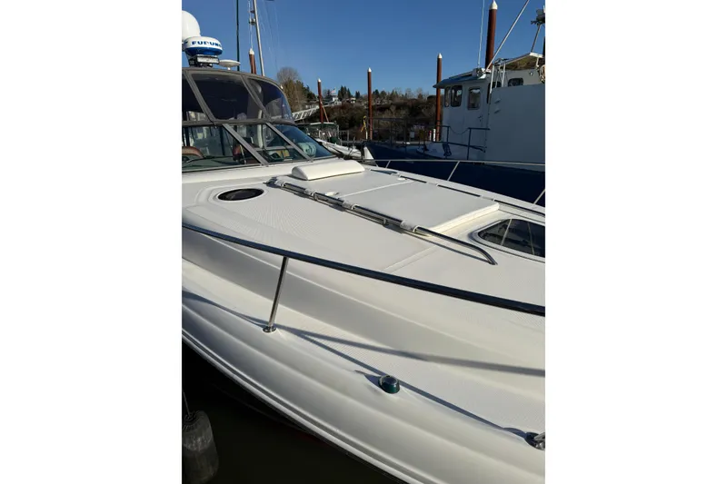 Slide: The Image of 2006 Sea Ray 340 Sundancer boat docked, showcasing sleek white exterior and modern design. - 5