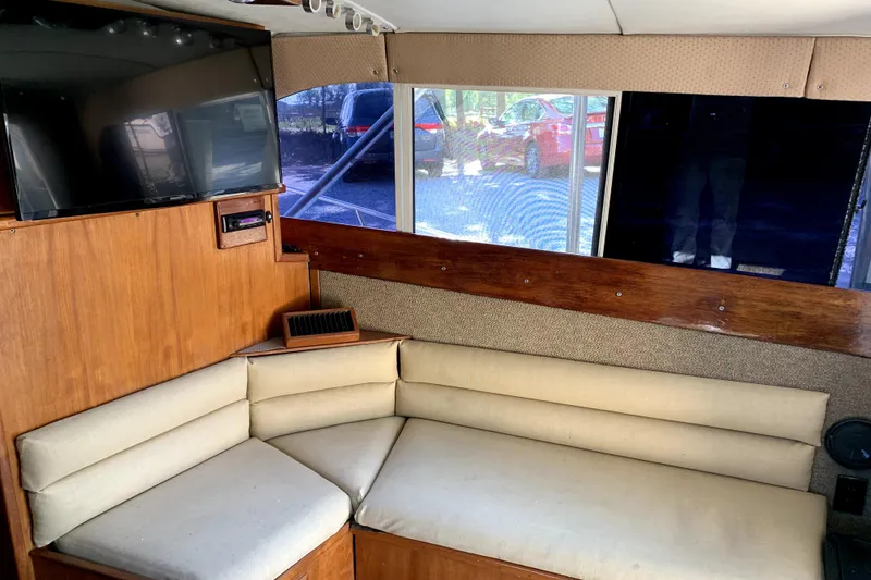 Slide: The Image of Interior of 1991 Pacemaker 37 Sportfisherman with cozy seating and mounted TV. - 12