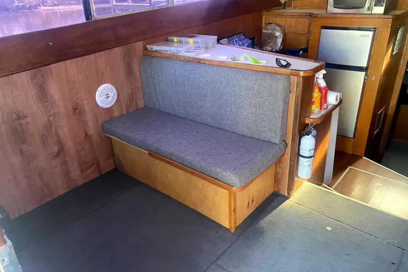 Slide: The Image of Interior of 1991 Pacemaker 37 Sportfisherman with seating, kitchenette, and storage. - 14