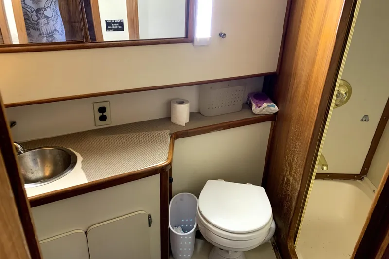 Slide: The Image of Bathroom interior of 1991 Pacemaker 37 Sportfisherman boat with sink, toilet, and shower. - 18