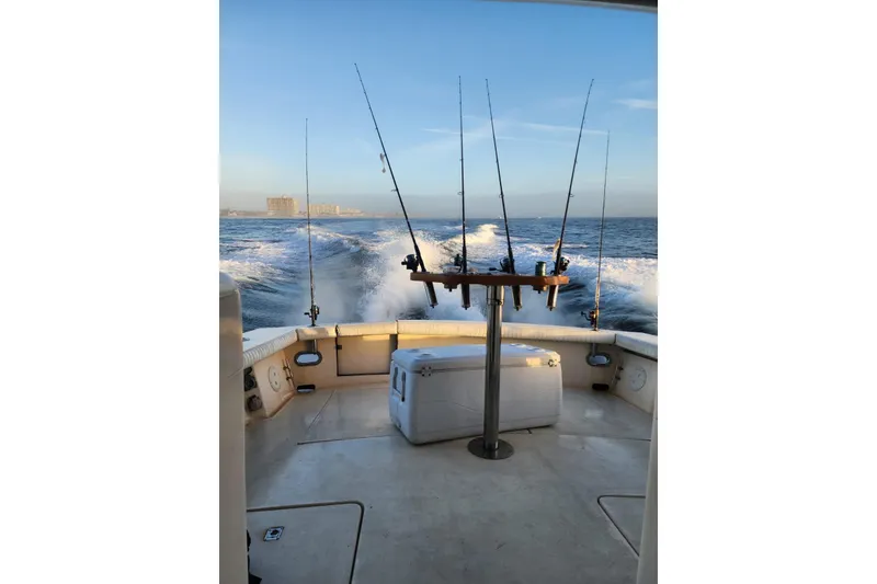 Slide: The Image of 1991 Pacemaker 37 Sportfisherman boat with fishing rods, cruising on open water. - 26