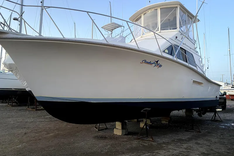 Slide: The Image of 1991 Pacemaker 37 Sportfisherman boat on dry dock, side view. - 5