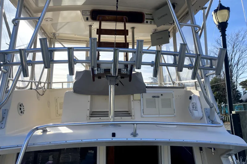 Slide: The Image of 1991 Pacemaker 37 Sportfisherman boat with fishing rod holders and navigation equipment. - 7