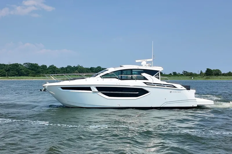 The Image of 2024 Cruisers Yachts 42 Cantius cruising on a sunny day, side view. - 0