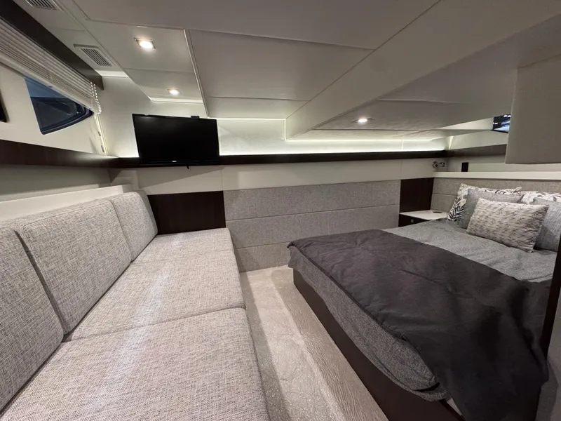 Slide: The Image of Luxurious interior of 2024 Cruisers Yachts 42 Cantius with modern furnishings and cozy bedding. - 16