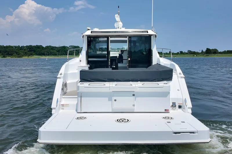 Slide: The Image of 2024 Cruisers Yachts 42 Cantius on water, rear view showcasing sleek design. - 3