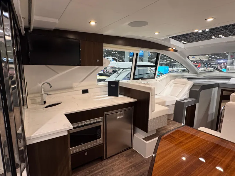 Slide: The Image of Luxurious interior of 2024 Cruisers Yachts 42 Cantius with modern kitchen and seating area. - 8