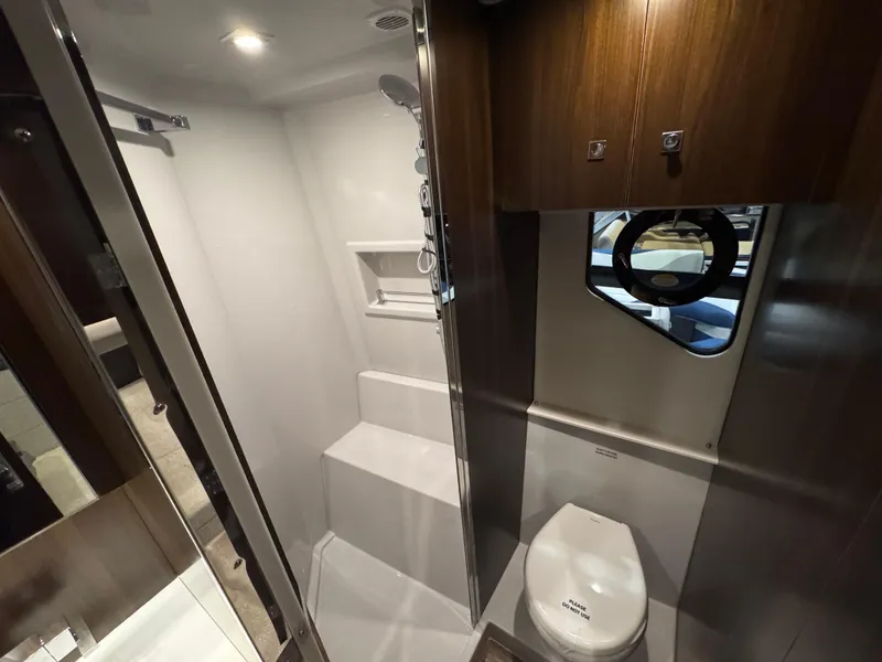 Slide: The Image of 2024 Cruisers Yachts 42 Cantius bathroom with modern fixtures and wood accents. - 18