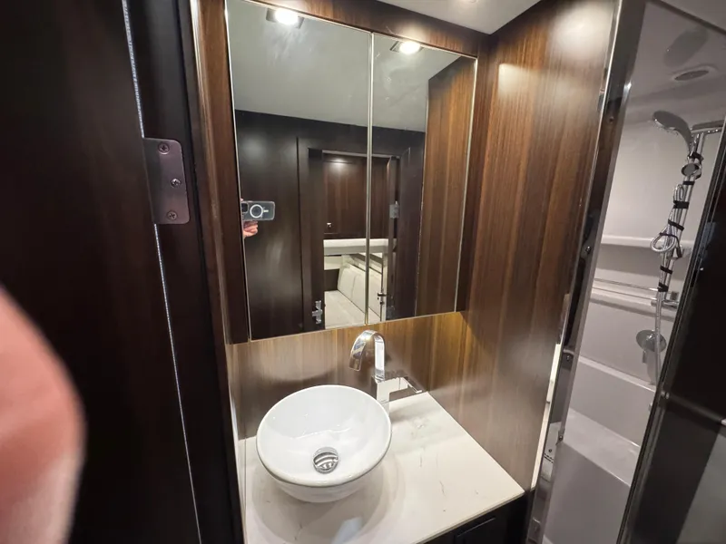 Slide: The Image of Luxurious bathroom in 2024 Cruisers Yachts 42 Cantius with modern sink and wood accents. - 19