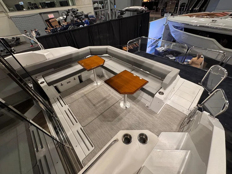 Slide: The Image of 2024 Cruisers Yachts 42 Cantius cockpit with seating and wooden tables. - 22