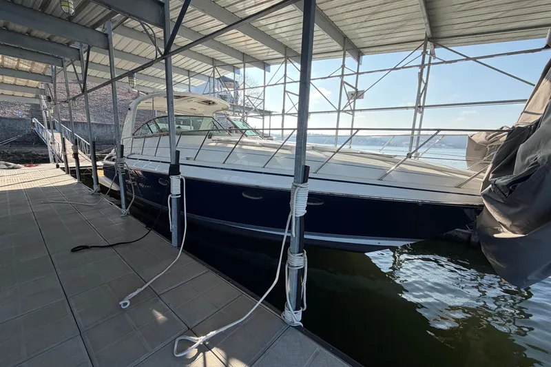 The Image of 2005 Formula 48 Yacht on serene water with marina backdrop. - 0