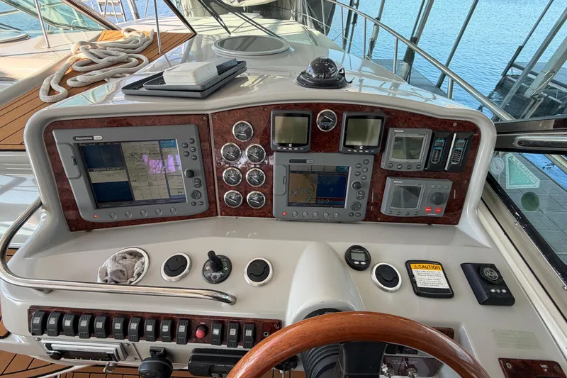 Slide: The Image of Dashboard of a 2005 Formula 48 Yacht showing system status and gauges. - 16