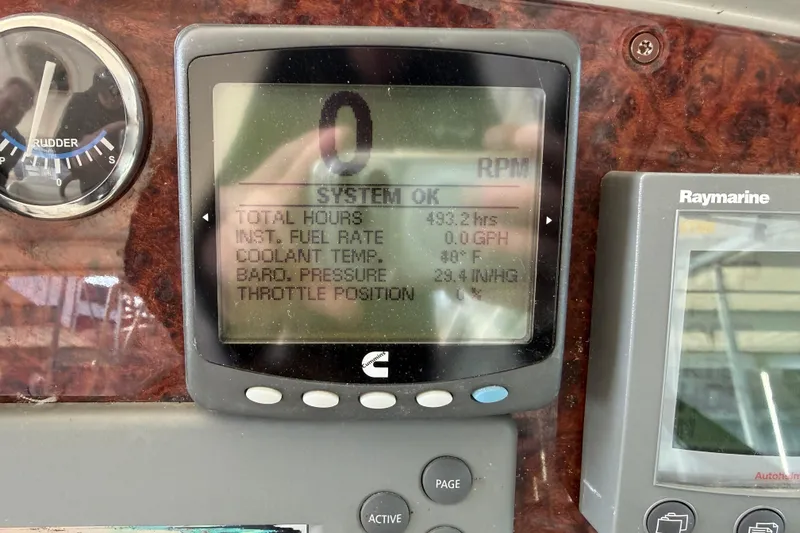 Slide: The Image of 2005 Formula 48 Yacht docked, showcasing sleek design and spacious deck under marina structure. - 21