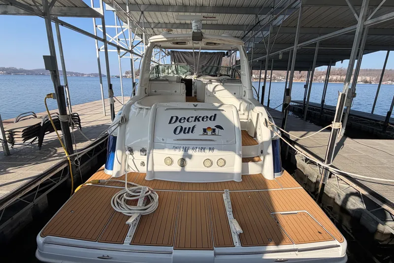 Slide: The Image of 2005 Formula 48 Yacht docked, featuring spacious deck and serene waterfront view. - 4