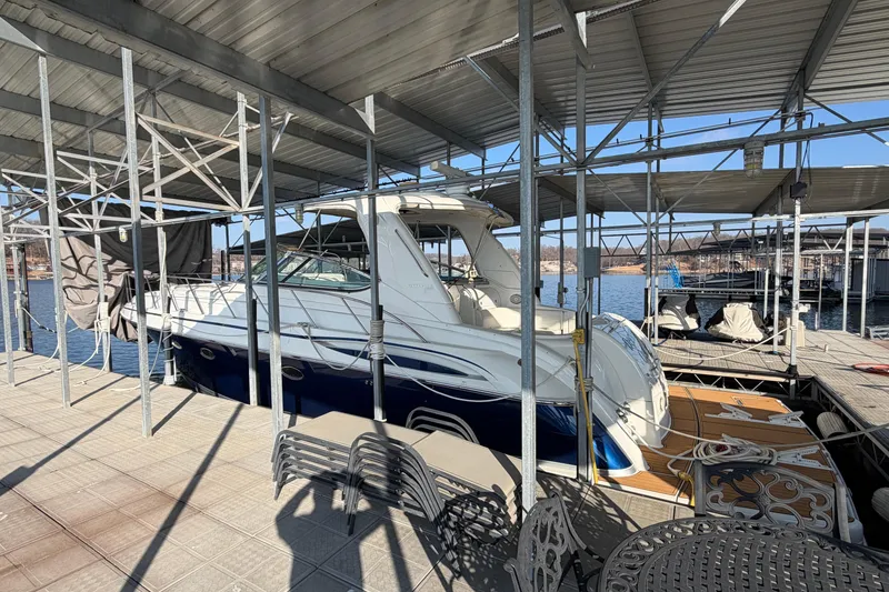 Slide: The Image of 2005 Formula 48 Yacht docked, featuring spacious deck and covered marina setting. - 5