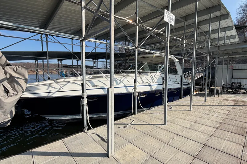 Slide: The Image of 2005 Formula 48 Yacht docked under a covered marina on a sunny day. - 6