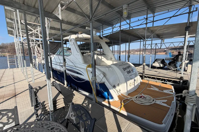 Slide: The Image of 2005 Formula 48 Yacht docked under a covered marina on a sunny day. - 8