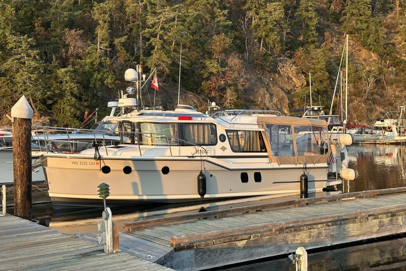The Image of 2025 Ranger Tugs R-29 S docked in a serene marina setting. - 0