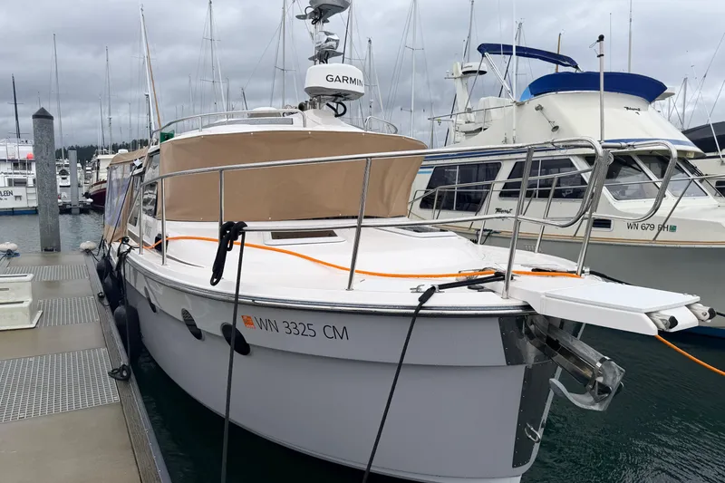 Slide: The Image of 2025 Ranger Tugs R-29 S docked at marina, featuring sleek design and modern equipment. - 2