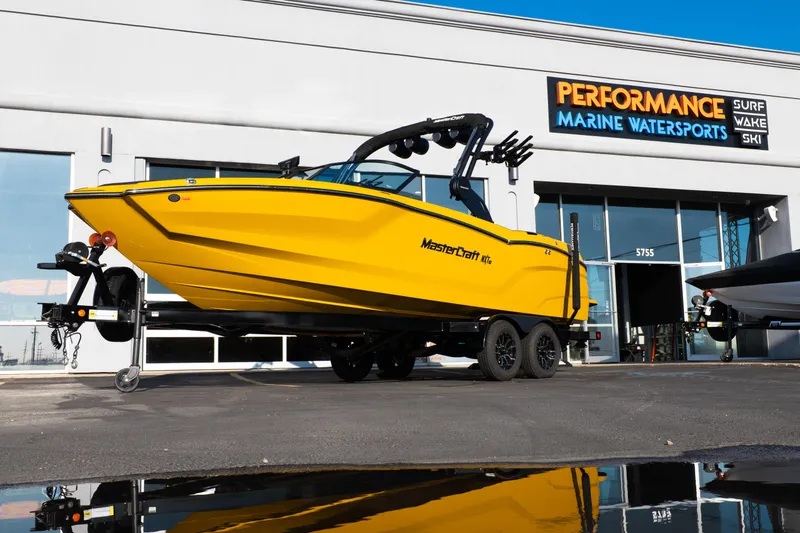 The Image of 2026 MasterCraft NXT23 boat in vibrant yellow outside Performance Marine Watersports. - 1