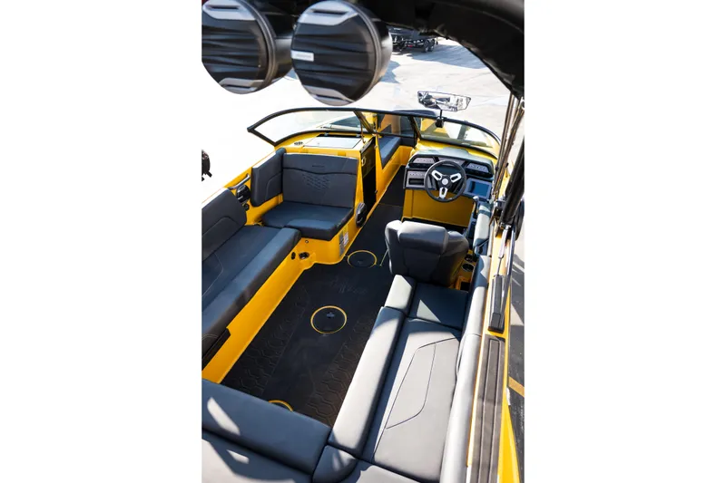 Slide: The Image of 2026 MasterCraft NXT23 boat interior with sleek black and yellow seating and modern dashboard. - 10