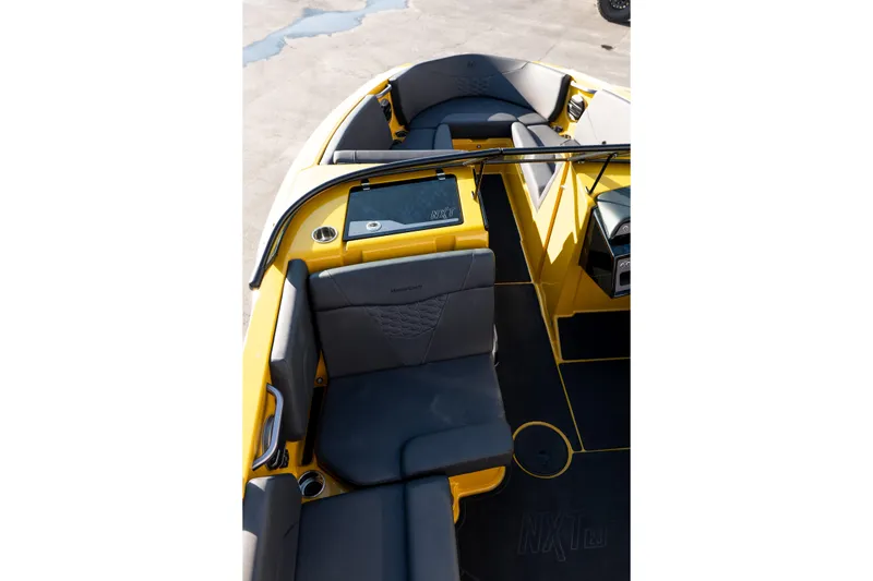 Slide: The Image of 2026 MasterCraft NXT23 boat interior with yellow and gray seating, modern design. - 15