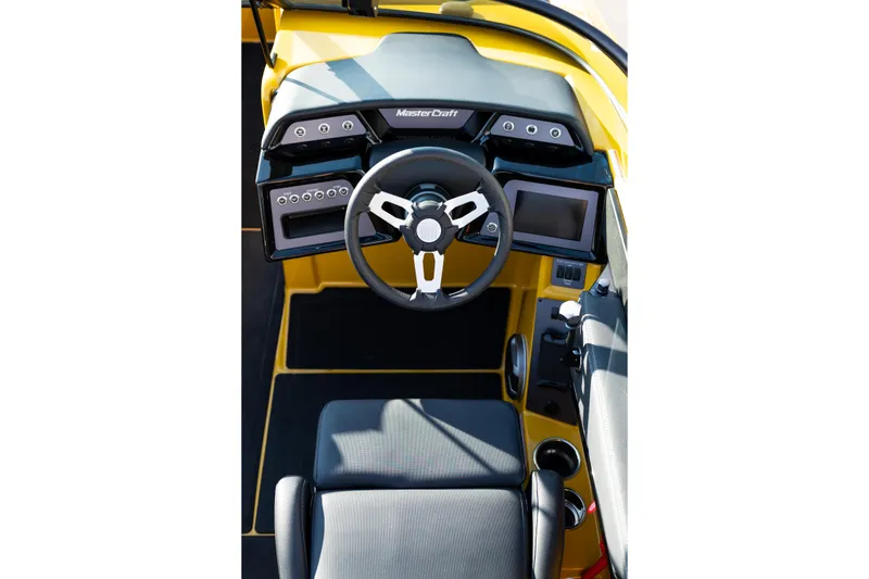 Slide: The Image of 2026 MasterCraft NXT23 boat cockpit with modern steering and digital controls. - 17