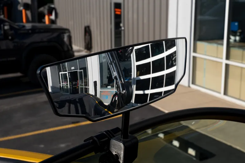 Slide: The Image of Side mirror reflection on 2026 MasterCraft NXT23 boat, showcasing modern design and surroundings. - 18