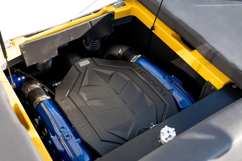 Slide: The Image of 2026 MasterCraft NXT23 engine compartment with Ilmor engine, showcasing blue and black components. - 21