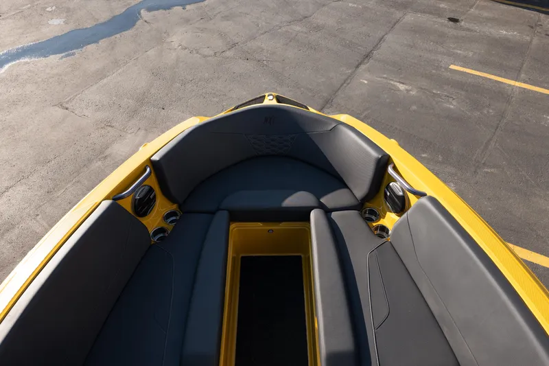 Slide: The Image of Interior view of 2026 MasterCraft NXT23 boat with yellow and gray seating. - 23
