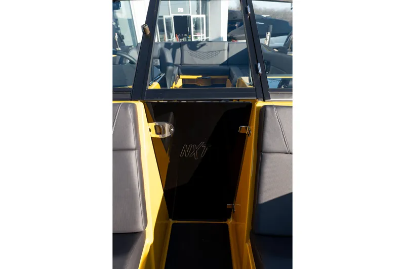 Slide: The Image of 2026 MasterCraft NXT23 boat interior with yellow accents and NXT logo. - 25