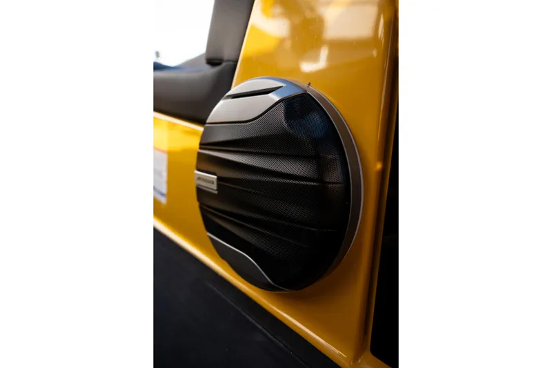 Slide: The Image of Close-up of a 2026 MasterCraft NXT23 boat speaker on a yellow panel. - 28
