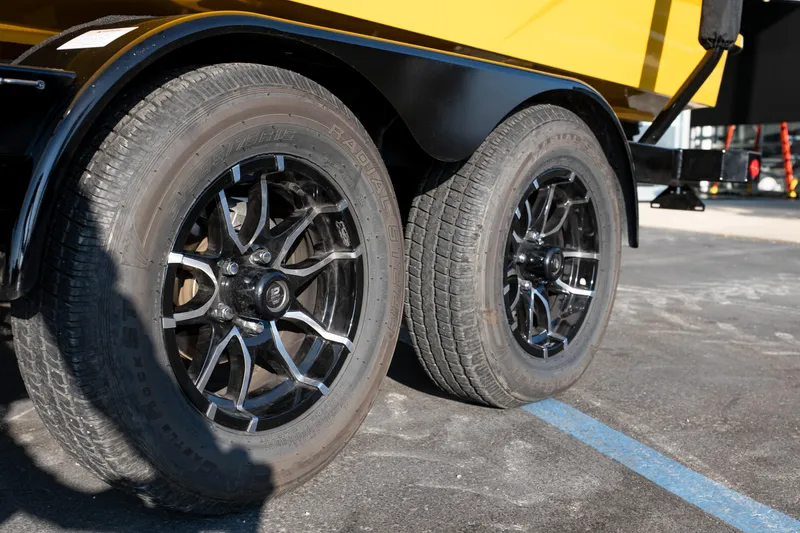 Slide: The Image of Trailer wheels of a 2026 MasterCraft NXT23 boat, featuring stylish black rims. - 43