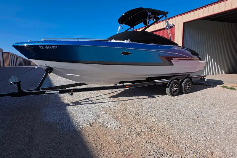 The Image of 2021 Formula 270 Bowrider boat on trailer, parked outside a storage unit. - 1