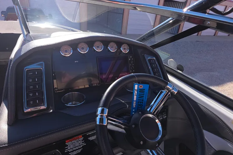 Slide: The Image of 2021 Formula 270 Bowrider dashboard with steering wheel and control panel. - 29