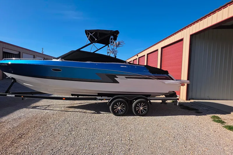 Slide: The Image of 2021 Formula 270 Bowrider boat on trailer, parked near storage units. - 3