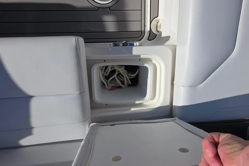 Slide: The Image of 2021 Formula 270 Bowrider storage compartment with rope, white interior detail. - 36