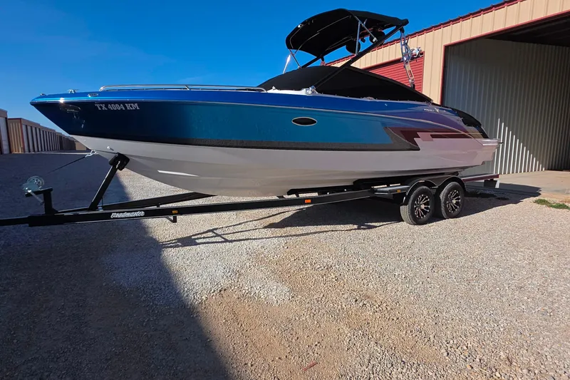 Slide: The Image of 2021 Formula 270 Bowrider boat on trailer, parked outside a storage unit. - 5