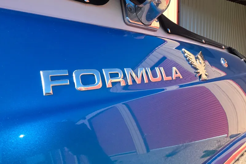 Slide: The Image of 2021 Formula 270 Bowrider boat with blue exterior and chrome logo. - 6