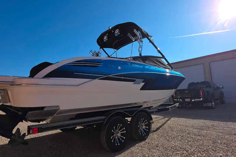 Slide: The Image of 2021 Formula 270 Bowrider boat on trailer under clear blue sky. - 9