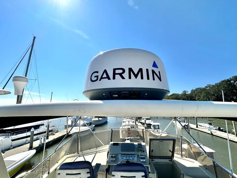 Slide: The Image of 1987 Hatteras 54 Motoryacht with Garmin radar, docked under clear blue sky. - 10