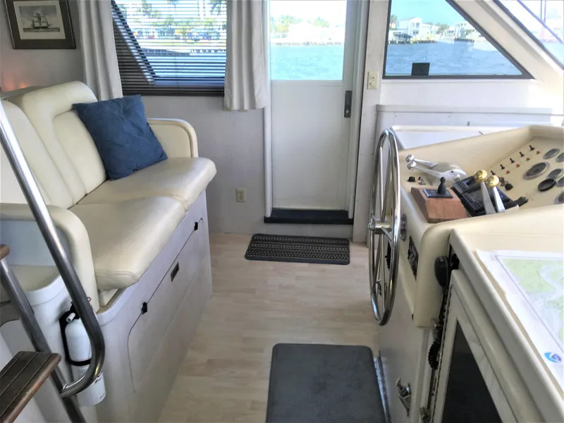 Slide: The Image of 1987 Hatteras 54 Motoryacht interior with helm, seating, and ocean view. - 2