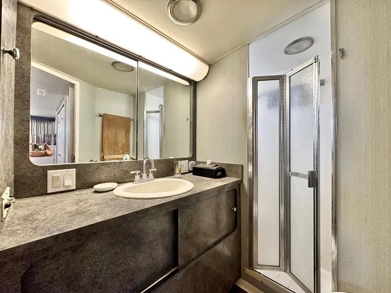 Slide: The Image of 1987 Hatteras 54 Motoryacht bathroom with modern sink and shower. - 26