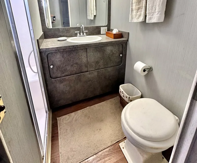 Slide: The Image of Bathroom interior of 1987 Hatteras 54 Motoryacht with sink, toilet, and shower. - 27