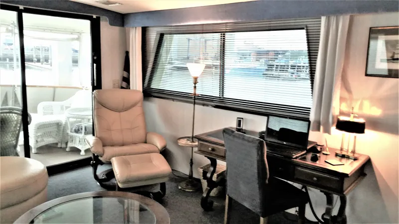 Slide: The Image of Interior of 1987 Hatteras 54 Motoryacht with desk, chair, and window view. - 4