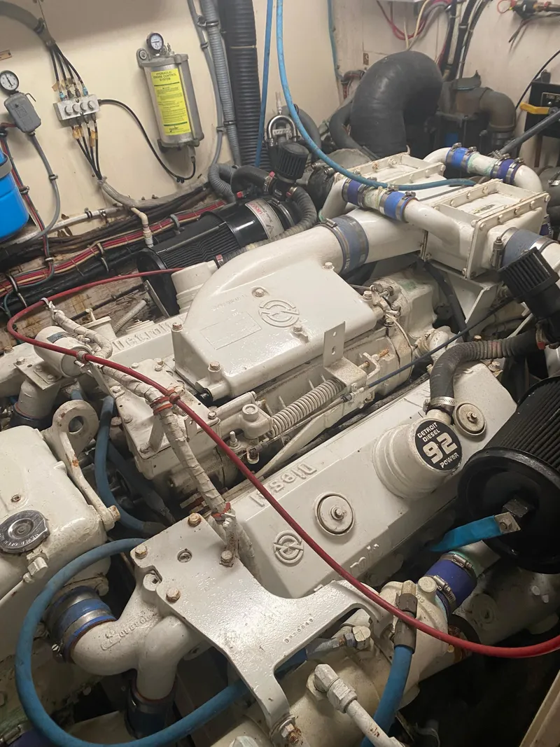 Slide: The Image of Engine room of a 1987 Hatteras 54 Motoryacht, showcasing mechanical components and wiring. - 41
