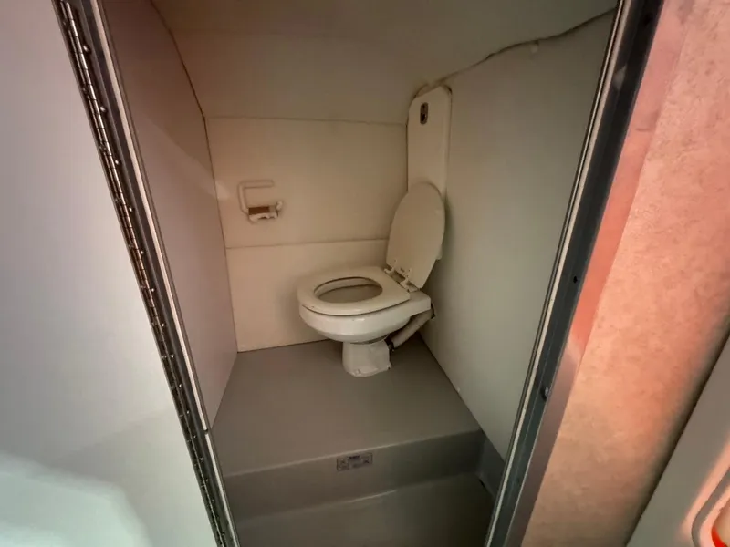 Slide: The Image of 2007 Baja 35 Outlaw boat interior bathroom with toilet. - 18