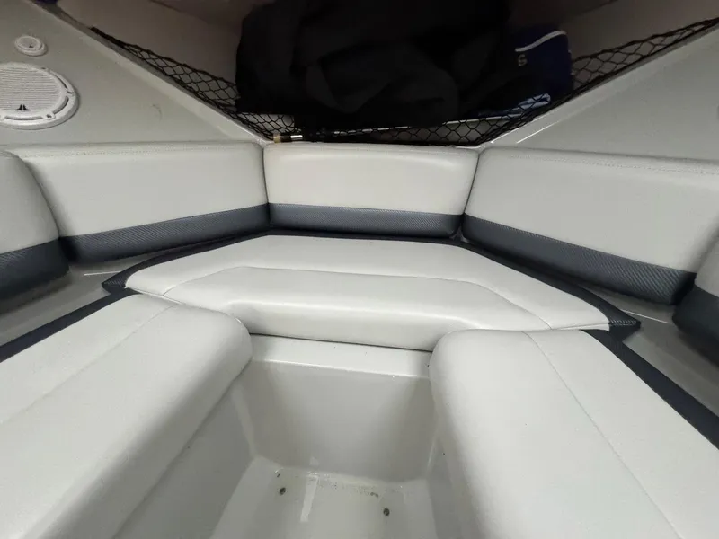 Slide: The Image of Interior seating of a 2007 Baja 35 Outlaw boat, featuring white and gray upholstery. - 21