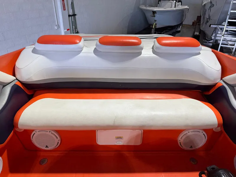 Slide: The Image of 2007 Baja 35 Outlaw boat interior with orange and white seating. - 25